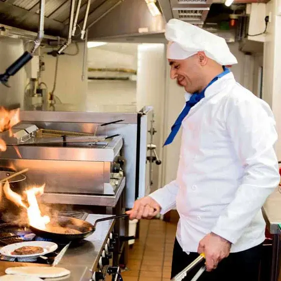Julian Estates Chef Created Meals, chef frying a dish.