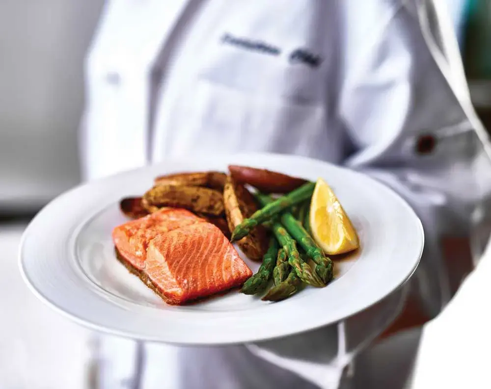 Julian Estates Chef Created Meals, chef delivering a finished dish.