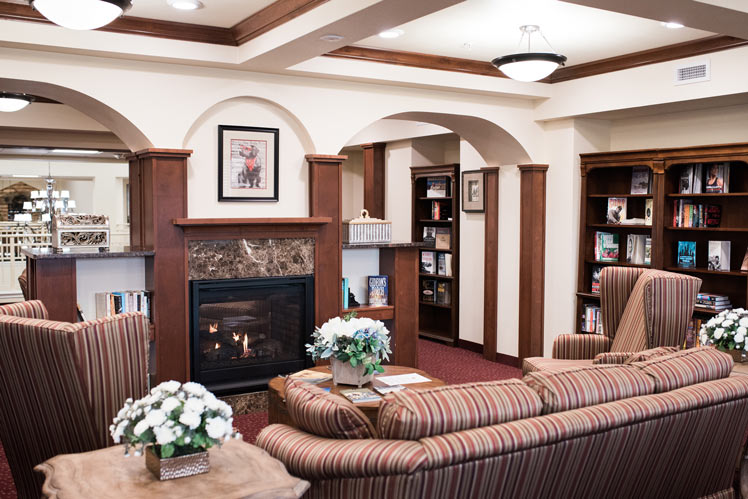 The library at Julian Estates with shelves of books and comfortable seating