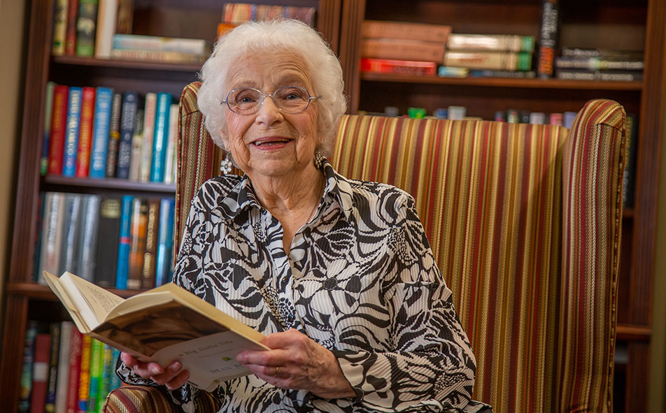 The library at Julian Estates with shelves of books and comfortable seating