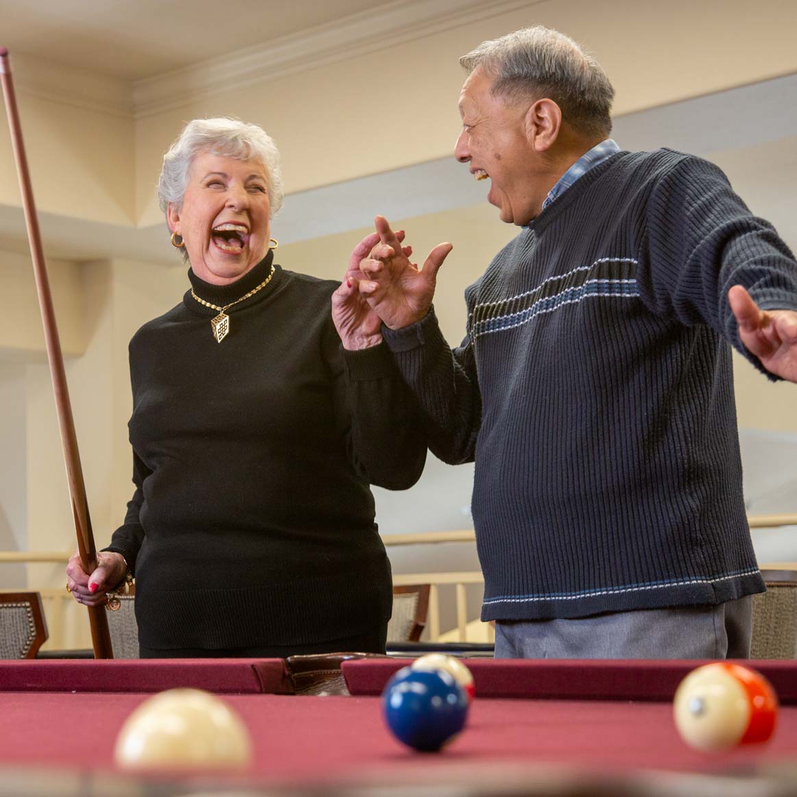 Residents playing billiards at Julian Estates